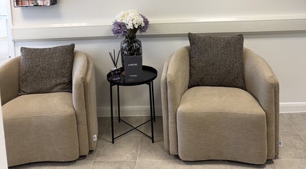 Comfortable seating area at Aesthetics by Jade, Newton Abbot, England, GB with elegant chairs and decor.