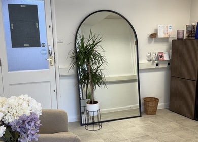 Cozy corner at Aesthetics by Jade, Newton Abbot, England, featuring elegant decor and lush greenery.