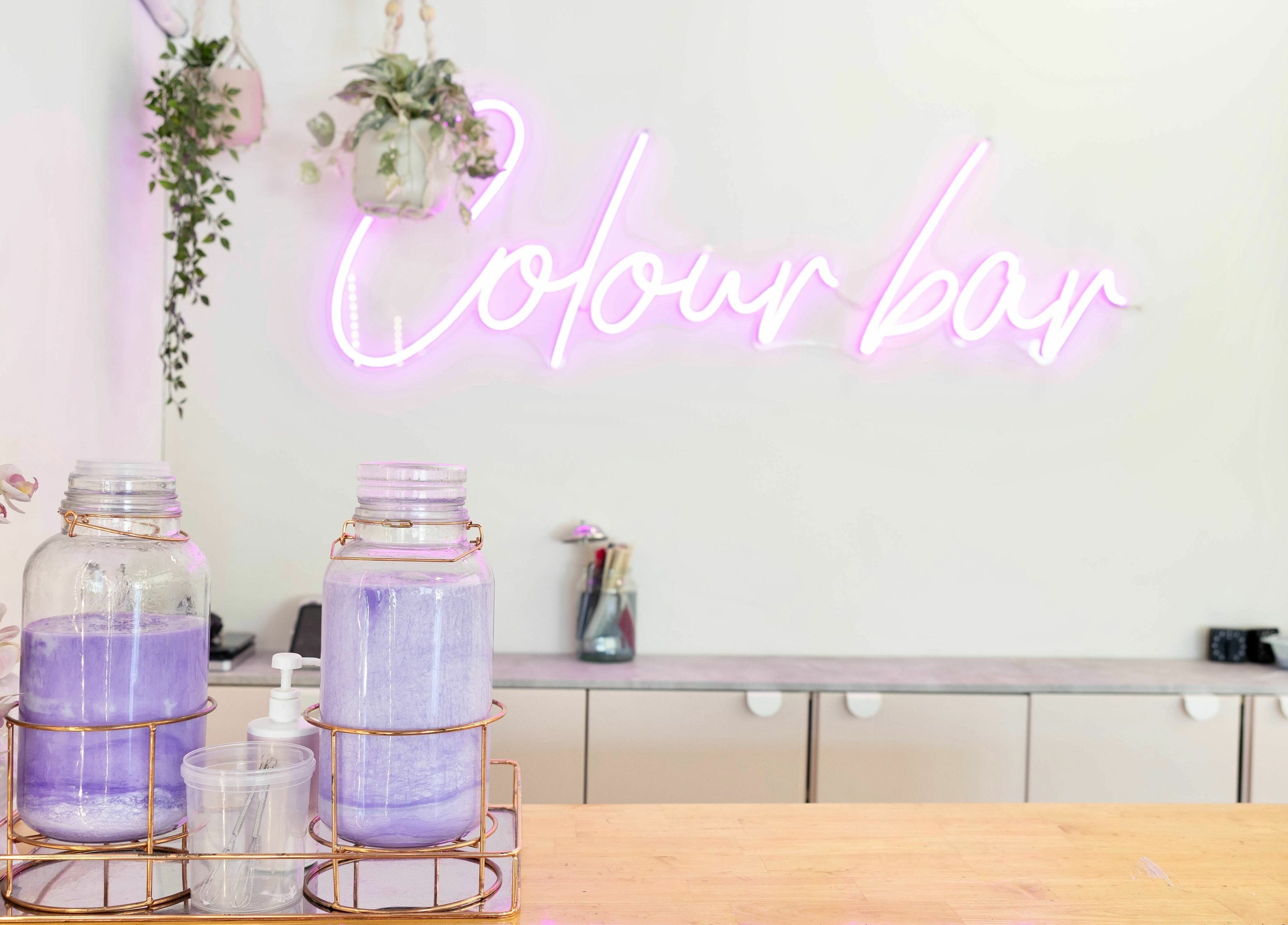Colour bar with lavender jars at Rapunzel Rapunzel, North Lakes, Queensland, AU. Modern salon decor.