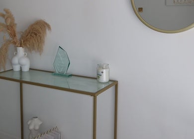 Stylish entryway at The Sculpt Studio EST 2018 in Sketty, Wales, GB with decor and a round mirror.