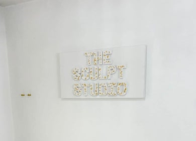 The Sculpt Studio EST 2018 logo on a white wall at Sketty, Wales, GB.
