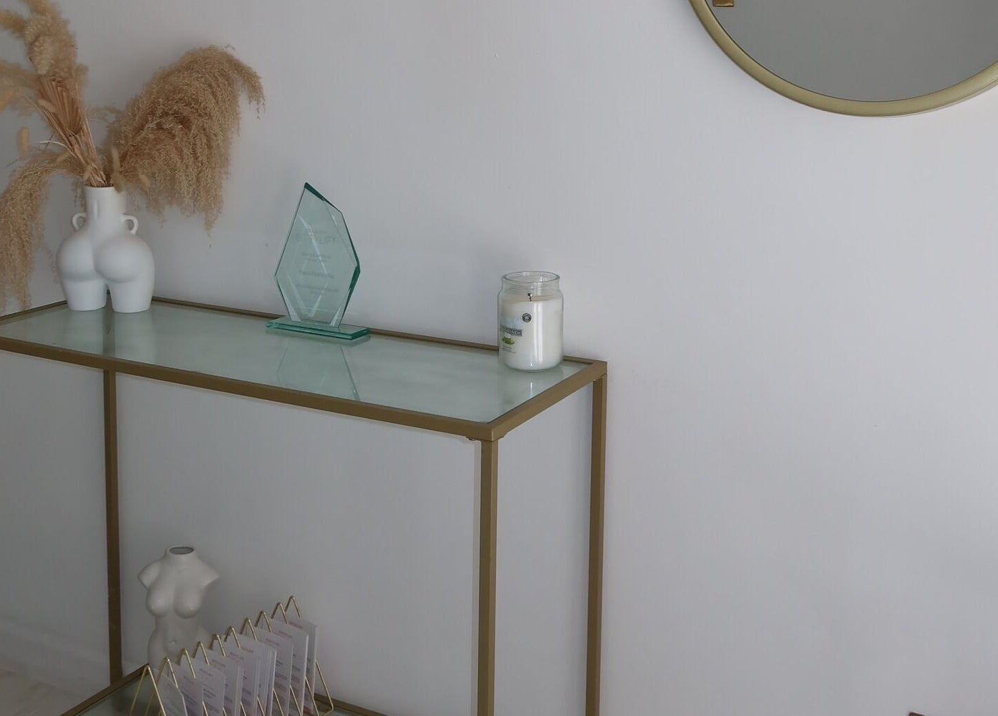 Elegant entryway at The Sculpt Studio EST 2018 in Sketty, Wales, GB with modern decor and glass table.