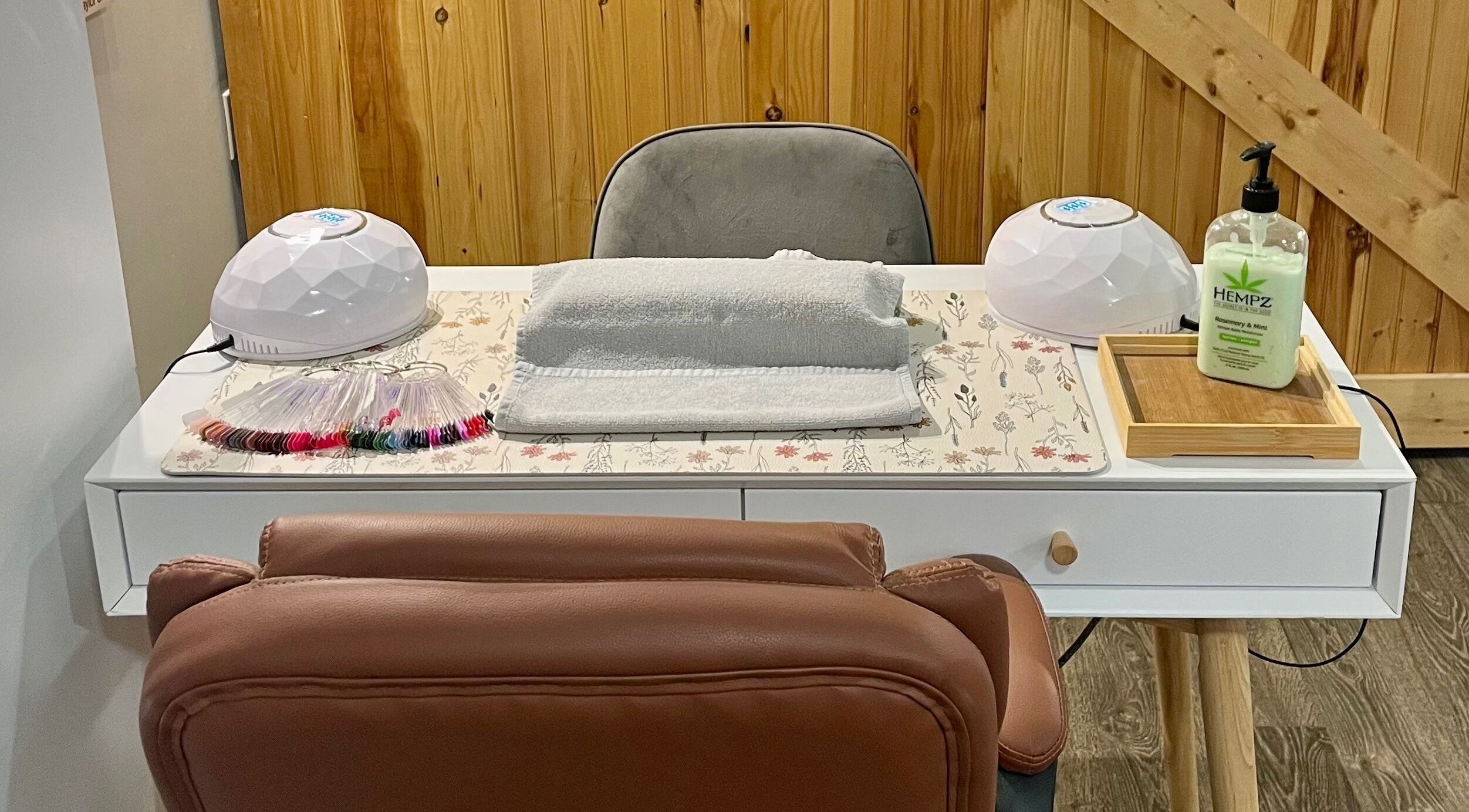 Nail station at Elemental Esthetics in Yarmouth, Nova Scotia, CA featuring manicure tools and comfy seating.