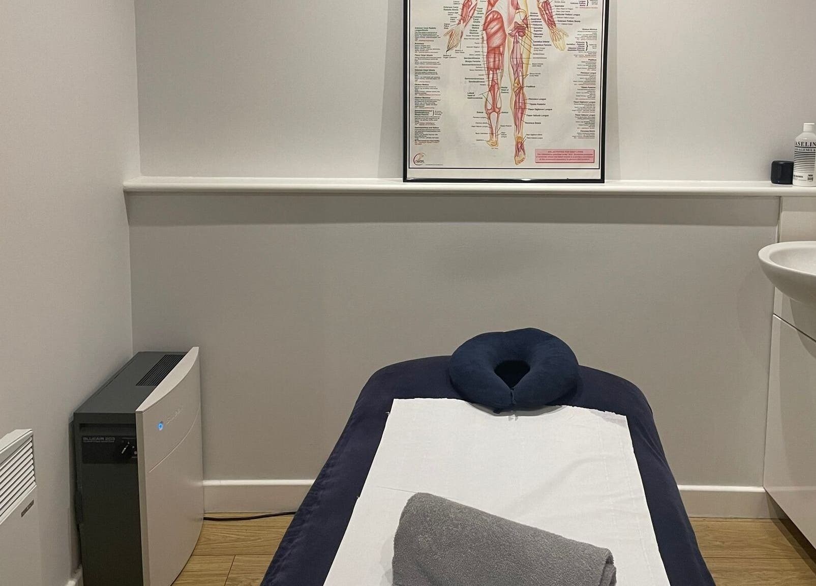 Serene treatment room at Therapy & Life Centre, Coulsdon, England, GB, featuring massage table and anatomical poster.