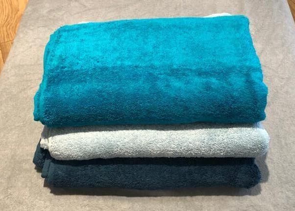 Colorful towels neatly stacked at Therapy & Life Centre, Coulsdon, England, GB.