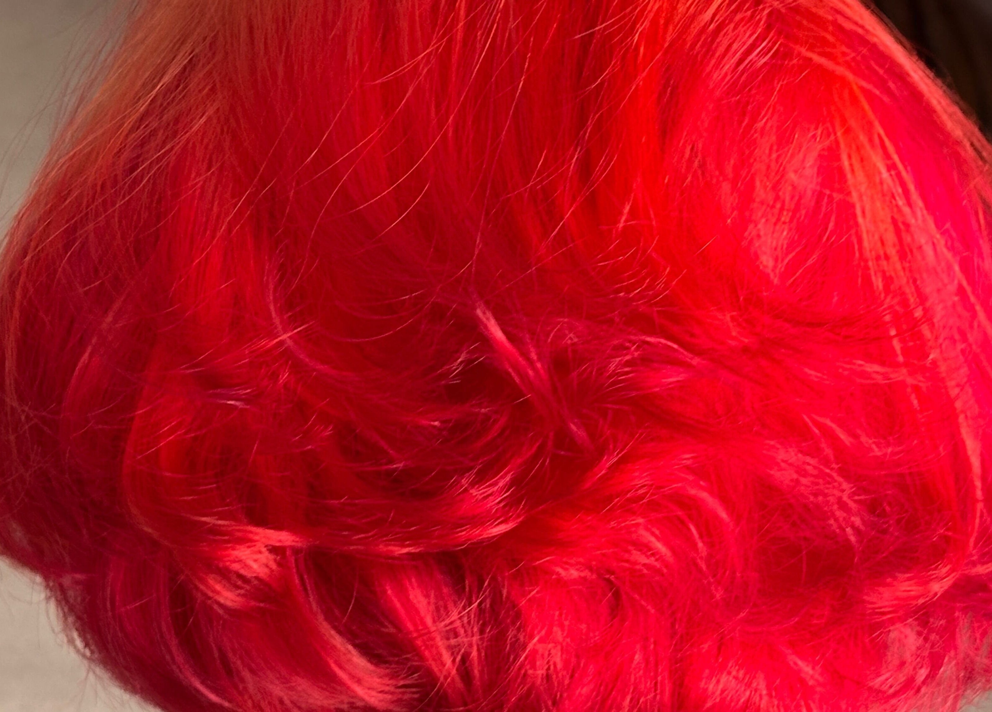 Vibrant red hairstyle at McIntyre’s Wig & Hairdressing Services, Dumfries, Scotland, GB.