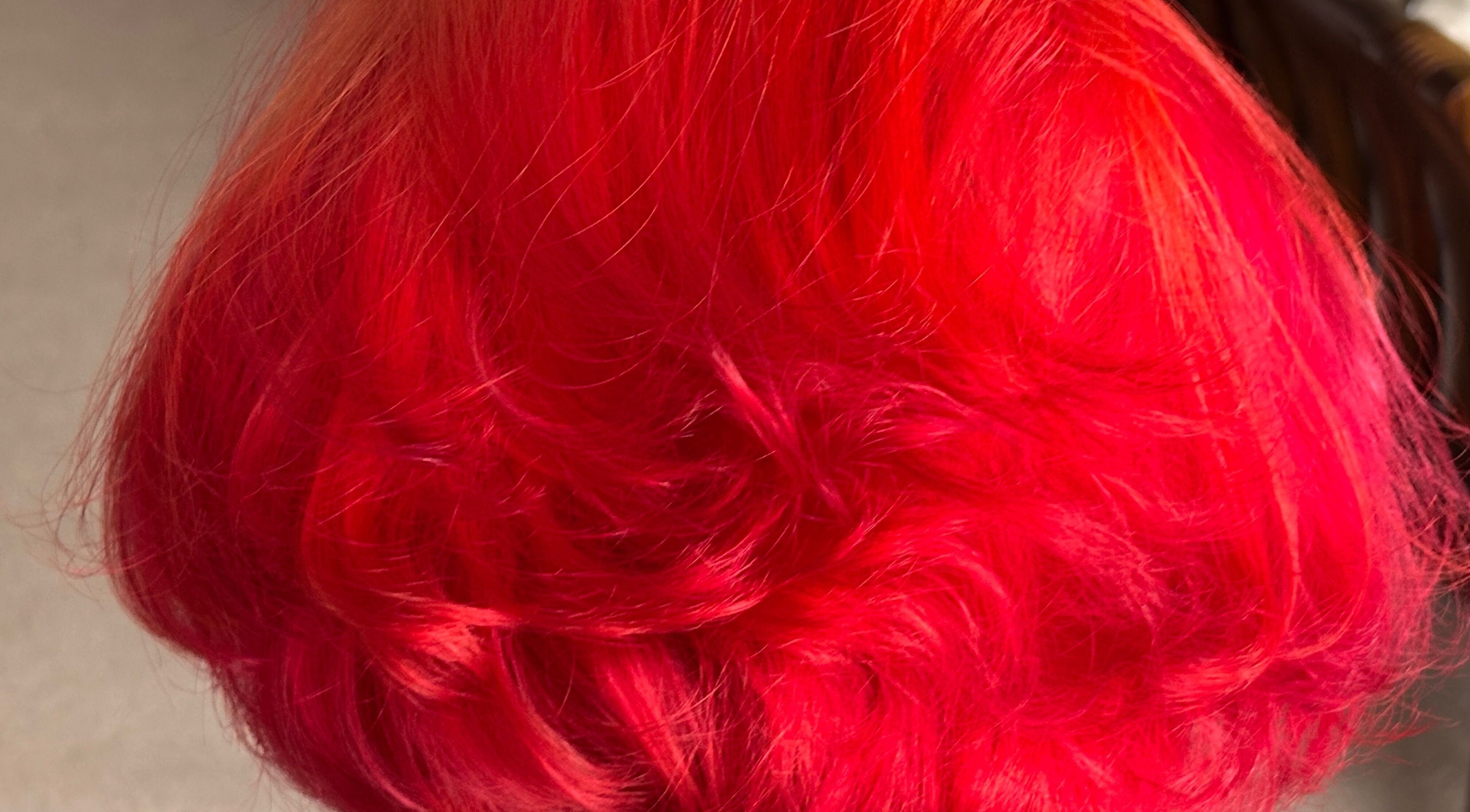 Vibrant red hairstyle at McIntyre’s Wig & Hairdressing Services, Dumfries, Scotland, GB.