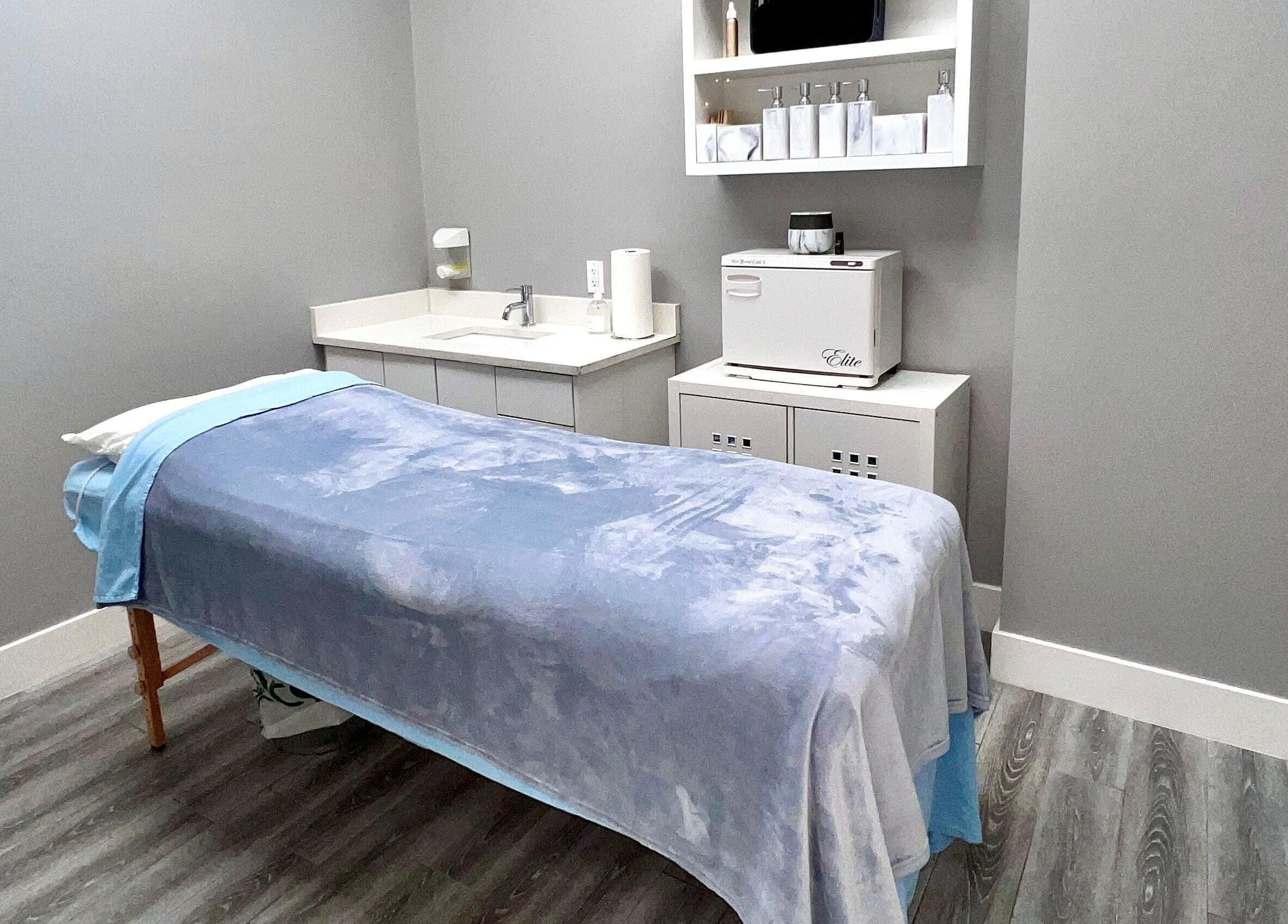 Tranquil treatment room at Diamond Beauty, Surrey, British Columbia, CA with soft blue bedding.