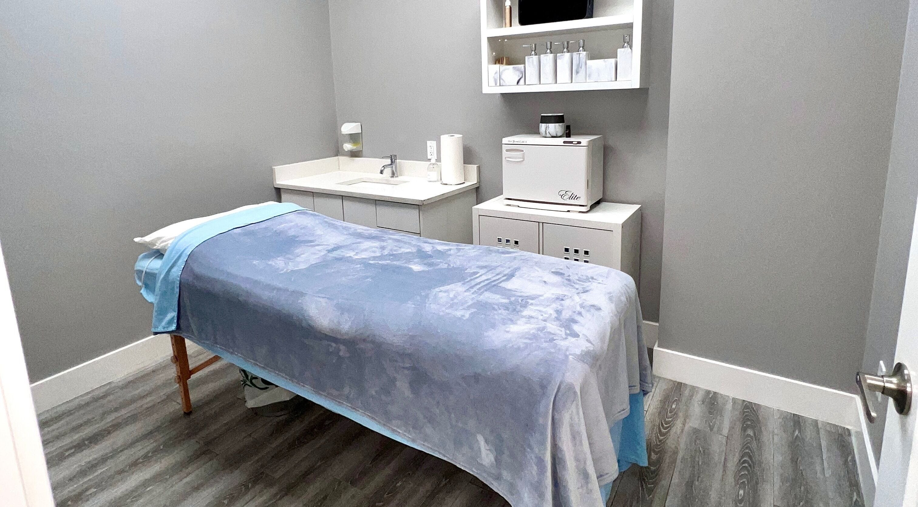 Tranquil treatment room at Diamond Beauty, Surrey, British Columbia, CA with soft blue bedding.