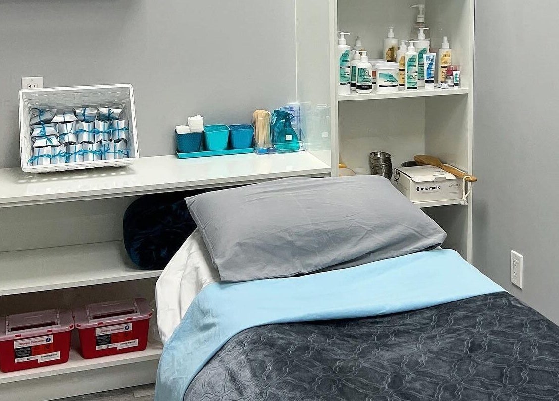 Cozy treatment room at Diamond Beauty in Surrey, British Columbia, CA with comfortable bed and skincare products.