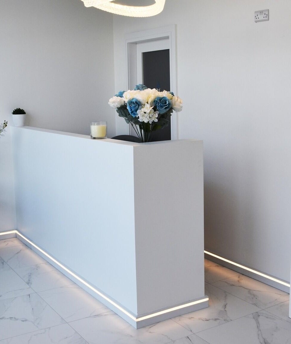 Elegant reception area at Ace Aesthetics, Ramelton, County Donegal, IE featuring plush seating and product display.