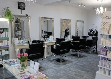Chic interior of Erika’s Beauty in Derby, England, GB showcasing stylish mirrors and product displays.