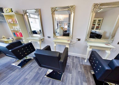 Elegant salon mirrors and chairs at Erika’s Beauty in Derby, England, GB, showcasing a stylish interior.