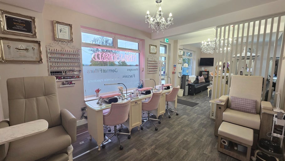 Spacious, elegant nail and beauty salon interior at Erika’s Beauty, Derby, England, GB, showcasing manicure stations.
