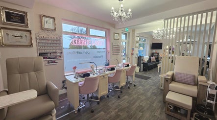 Spacious, elegant nail and beauty salon interior at Erika’s Beauty, Derby, England, GB, showcasing manicure stations.