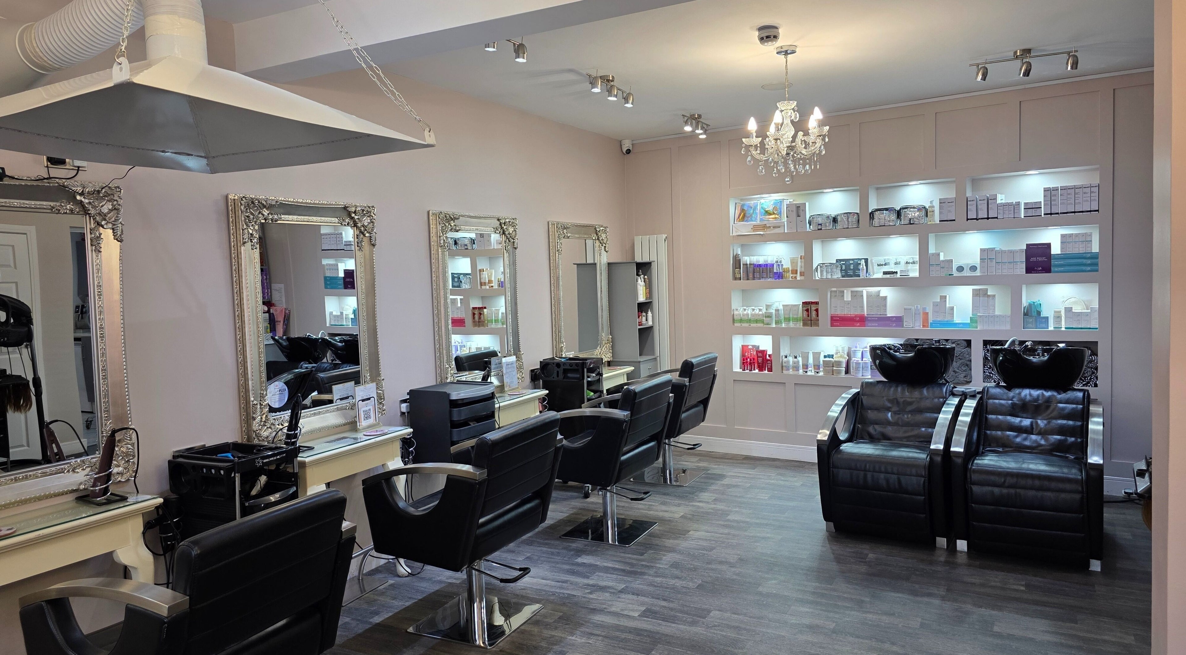 Elegant interior of Erika’s Beauty salon in Derby, England, GB with stylish chairs and mirrored walls.