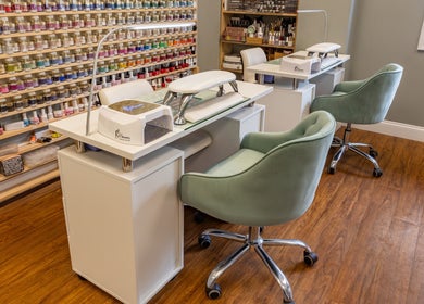 Beautyology nail salon in Ooltewah, Tennessee, US with colorful polish display and plush seating.