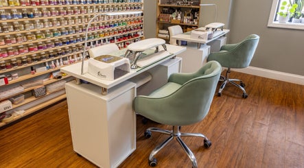 Beautyology nail salon in Ooltewah, Tennessee, US with colorful polish display and plush seating.