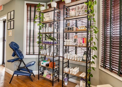 Beautyology Ooltewah, Tennessee venue showcasing wellness products and massage chair by bright window.