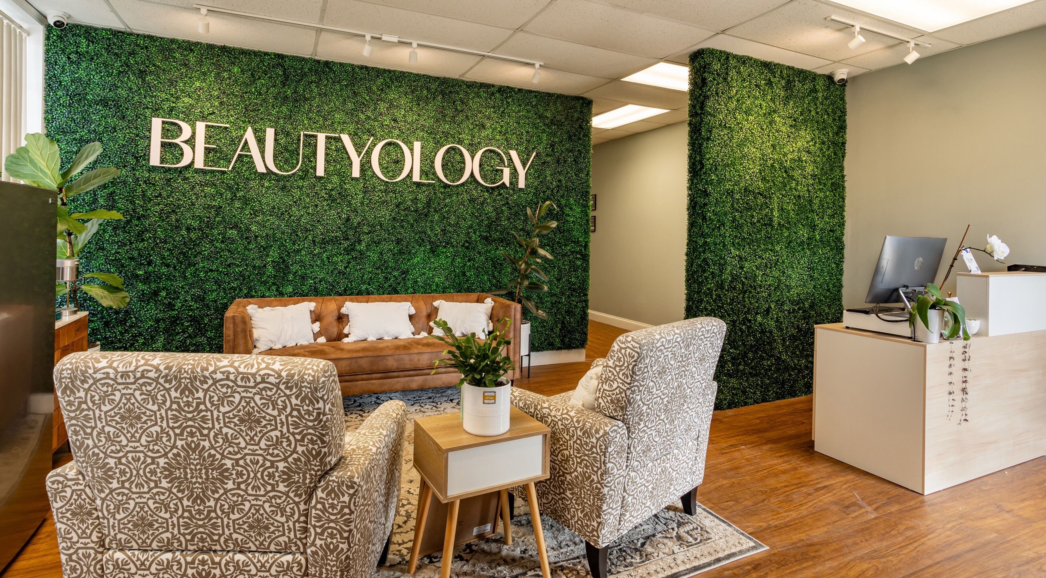 Chic reception area at BEAUTYOLOGY, Ooltewah, Tennessee, US with greenery and modern decor.