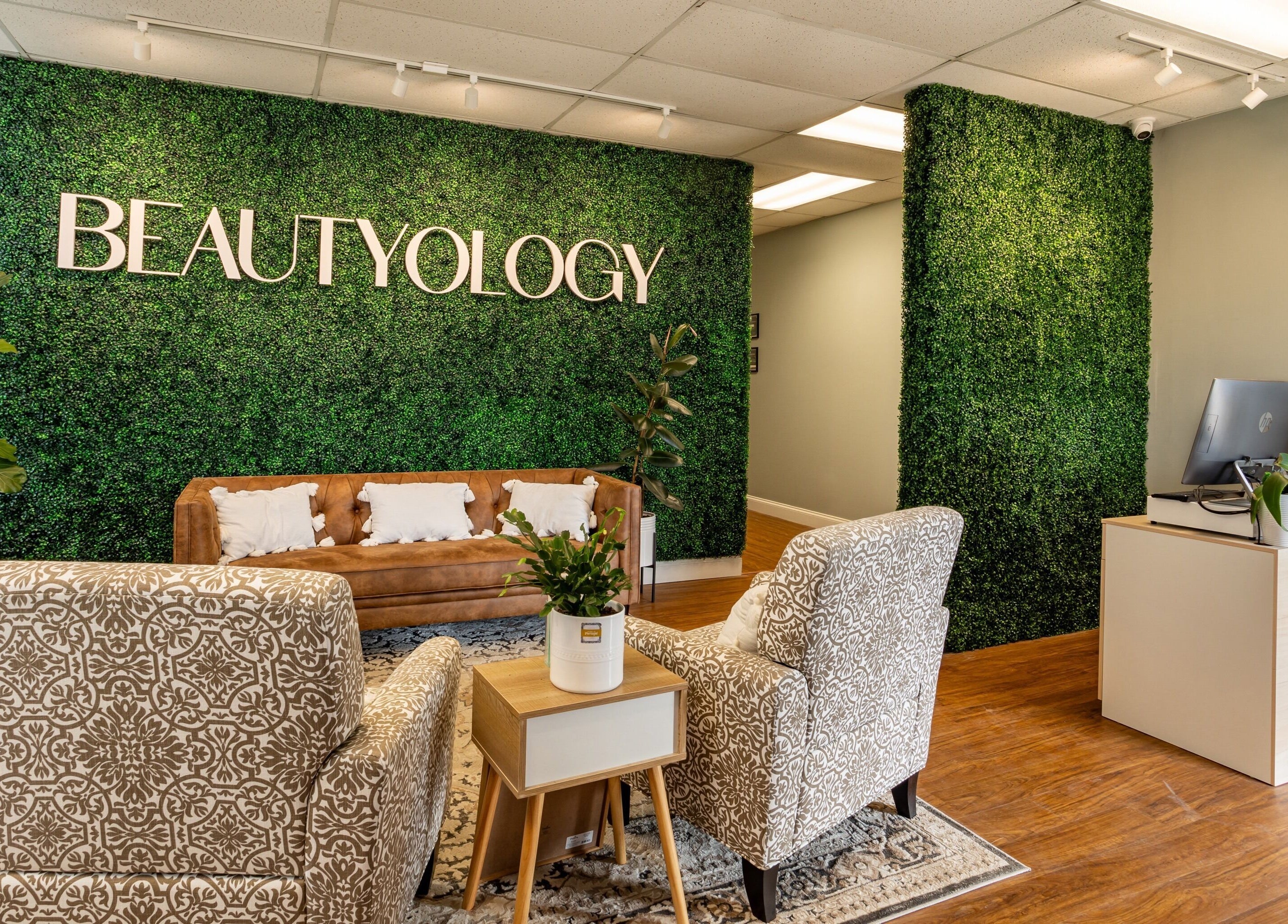 Stylish BEAUTYOLOGY reception with greenery wall in Ooltewah, Tennessee, US.