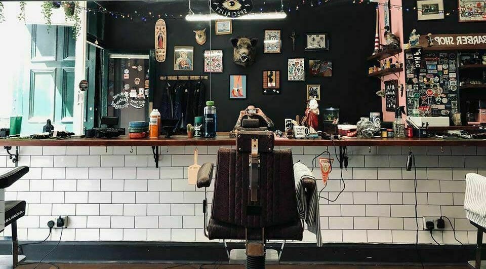 Inside view of Benjamin’s Barber Shop in Edinburgh, Scotland, GB featuring vintage decor and a barber chair.