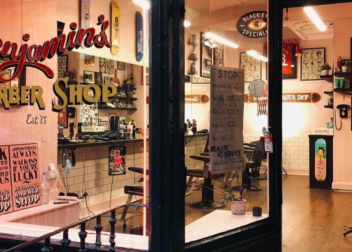 Cozy interior of Benjamin’s Barber Shop in Edinburgh, Scotland, GB showcasing vintage decor and classic barber chairs.