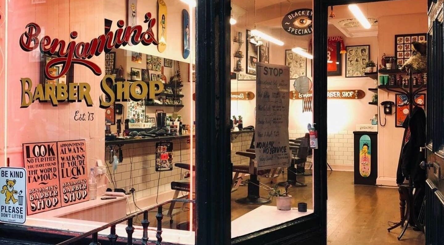 Cozy interior of Benjamin’s Barber Shop in Edinburgh, Scotland, GB showcasing vintage decor and classic barber chairs.