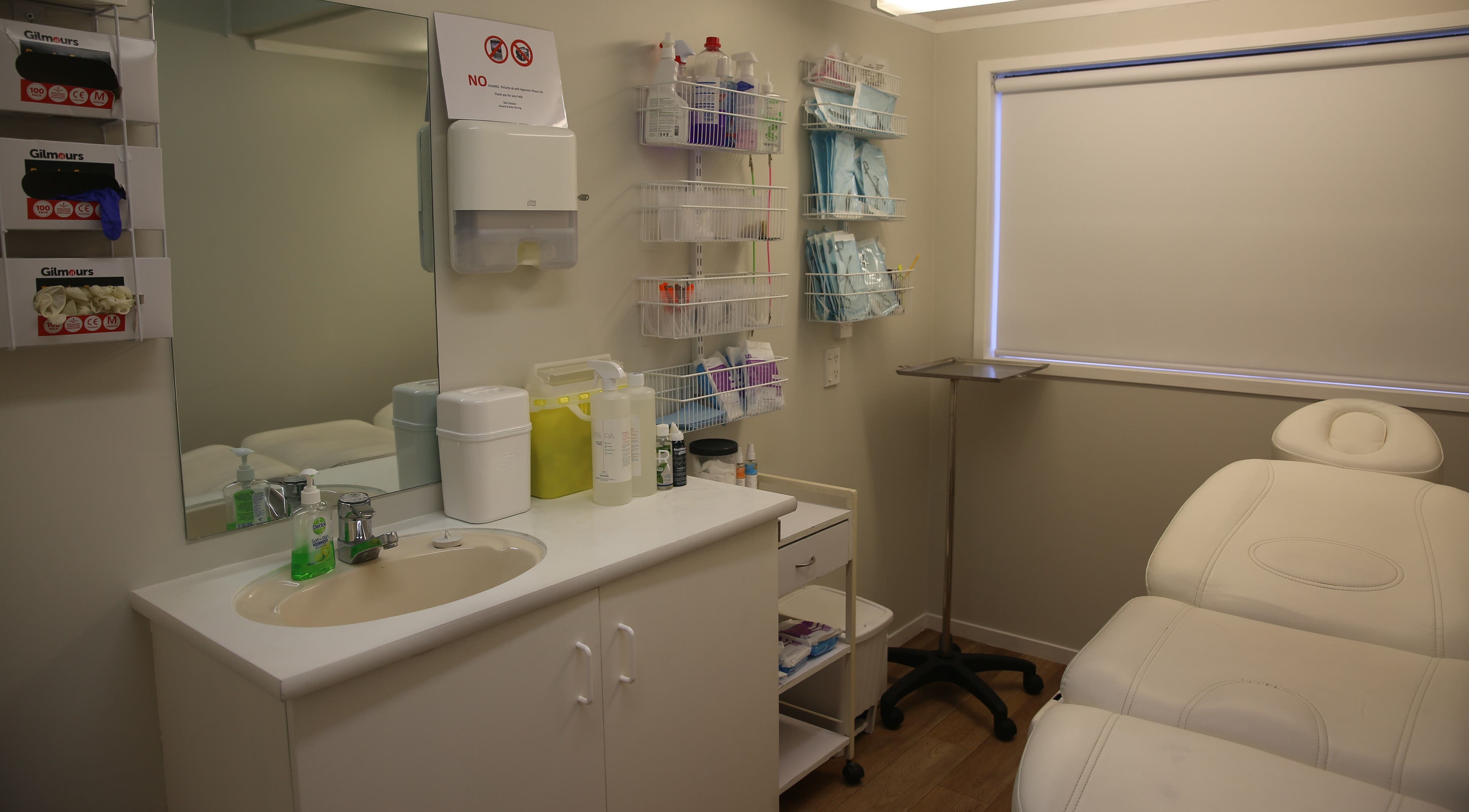 Elegant treatment room at Skin Passion, Red Beach, Auckland, NZ with a comfortable white therapy bed and clean facilities.