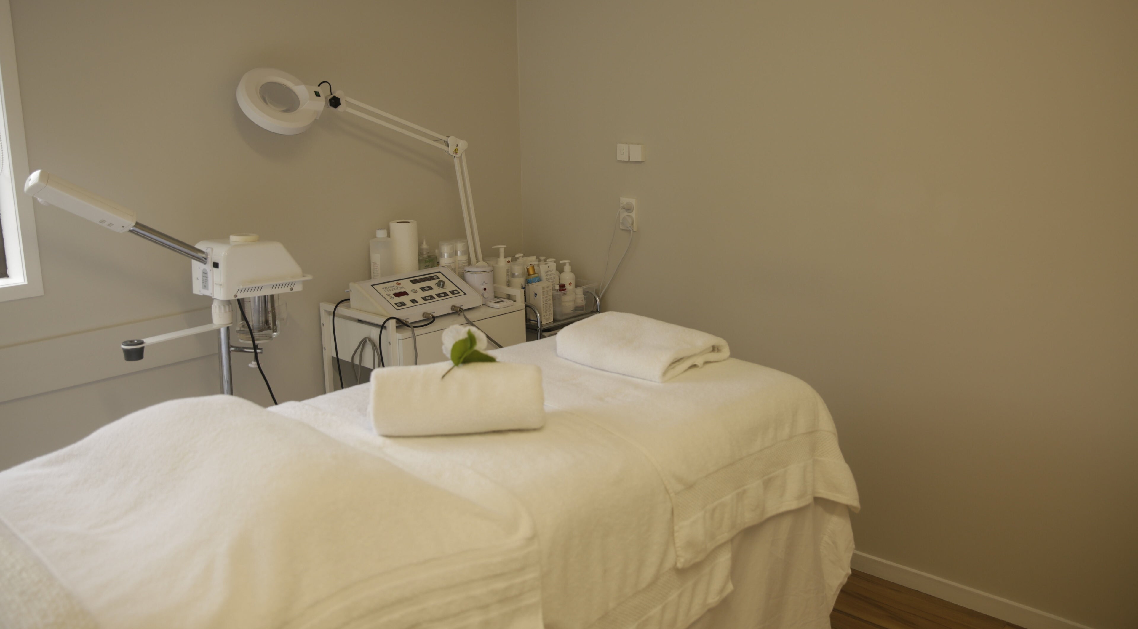 Tranquil treatment room at Skin Passion, Red Beach, Auckland, NZ featuring a massage table with fresh towels.