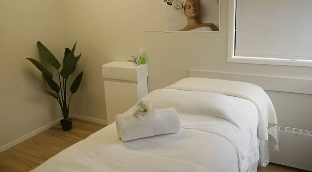 Tranquil treatment room at Skin Passion, Red Beach, Auckland, NZ featuring a neatly prepared massage table.