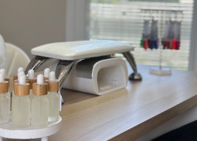 Nail spa setup at Charlotte Amelia Beauty, Penryn, England, GB showcasing manicure tools and bottles.