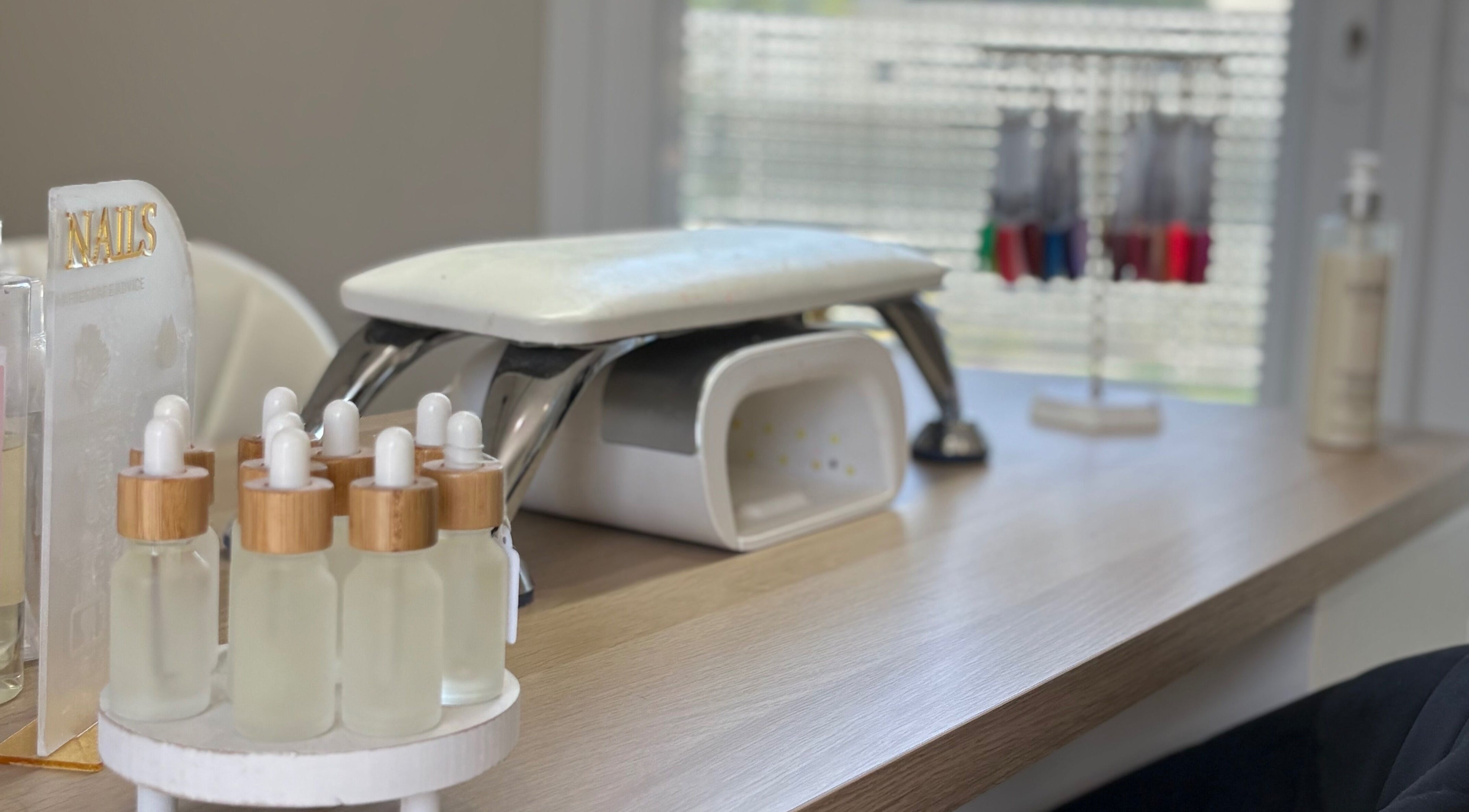 Nail spa setup at Charlotte Amelia Beauty, Penryn, England, GB showcasing manicure tools and bottles.