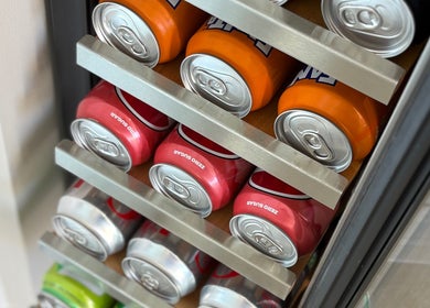 Colorful soda cans in a cooler at Charlotte Amelia Beauty, Penryn, England, GB.
