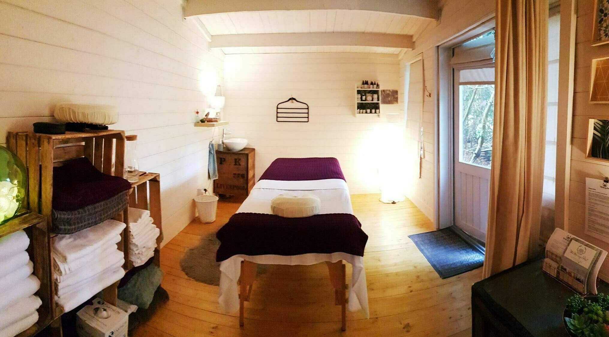 Cozy massage room at The Massage Hut, Cromer, England, GB, featuring a warm ambiance and tranquil decor.