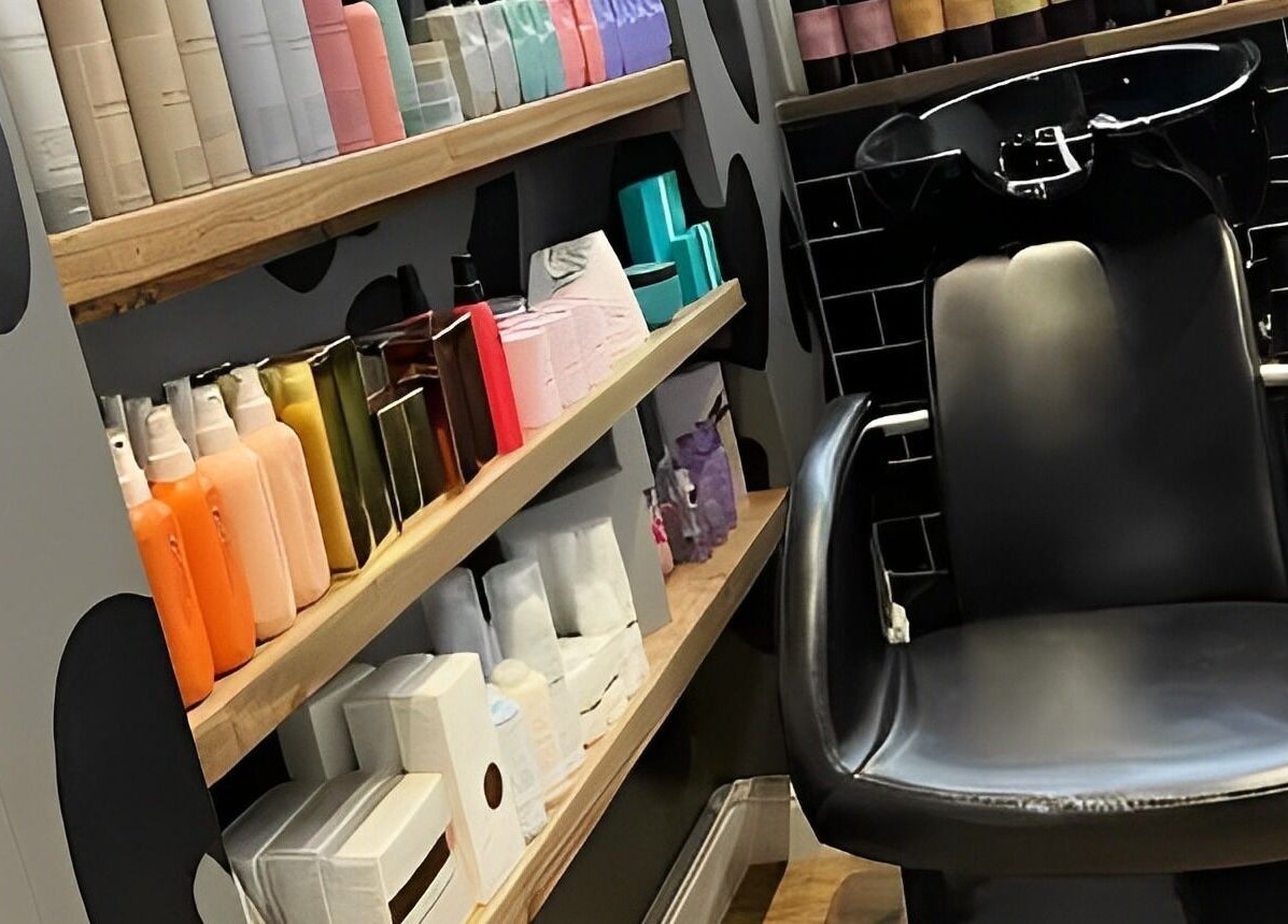 Hair washing station at Kaos, Keighley, England, GB showcasing products and sleek design.