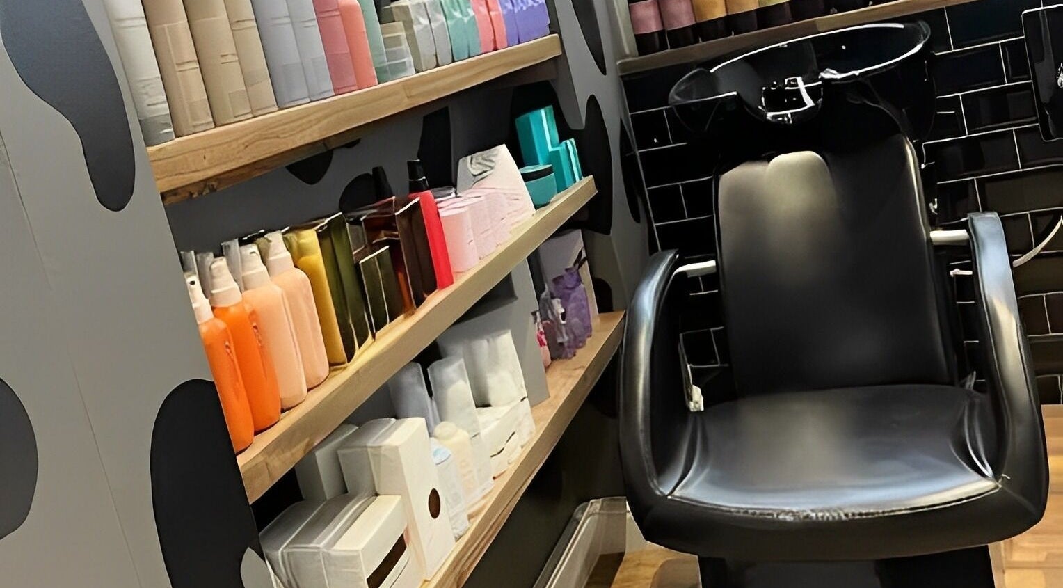 Hair washing station at Kaos, Keighley, England, GB showcasing products and sleek design.