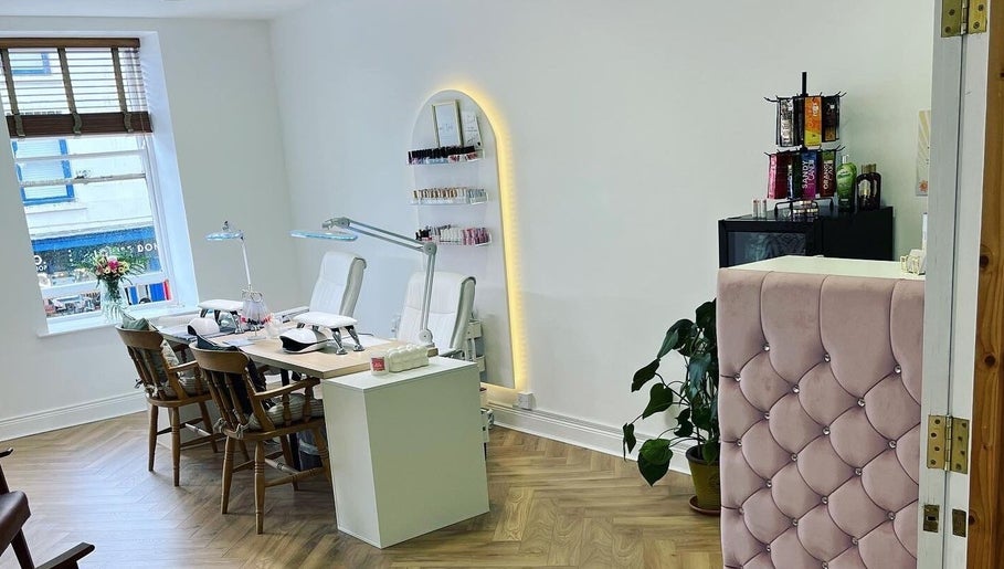 Modern beauty salon interior at HUTT Beauty, Ballycastle, Northern Ireland, GB featuring chic decor and nail stations.