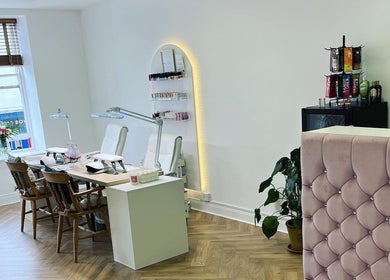 Modern beauty salon interior at HUTT Beauty, Ballycastle, Northern Ireland, GB featuring chic decor and nail stations.
