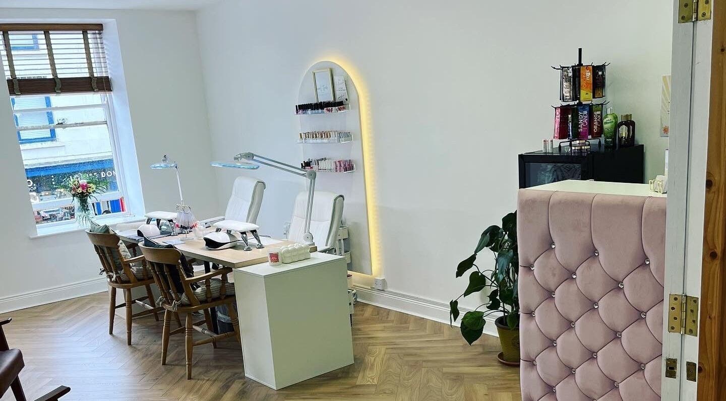 Modern beauty salon interior at HUTT Beauty, Ballycastle, Northern Ireland, GB featuring chic decor and nail stations.