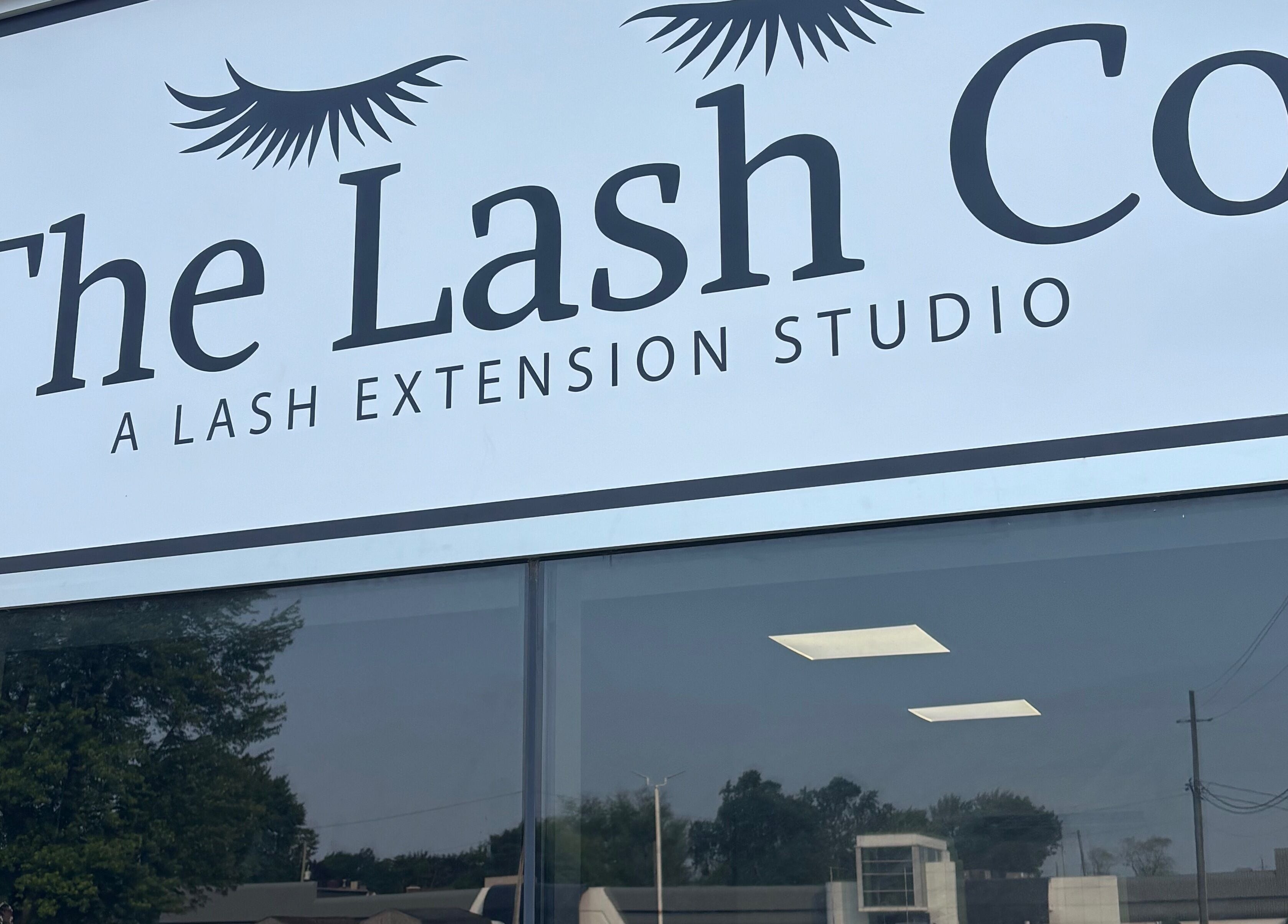 The Lash Co. storefront sign in Windsor, Ontario, CA, showcasing their lash extension studio.