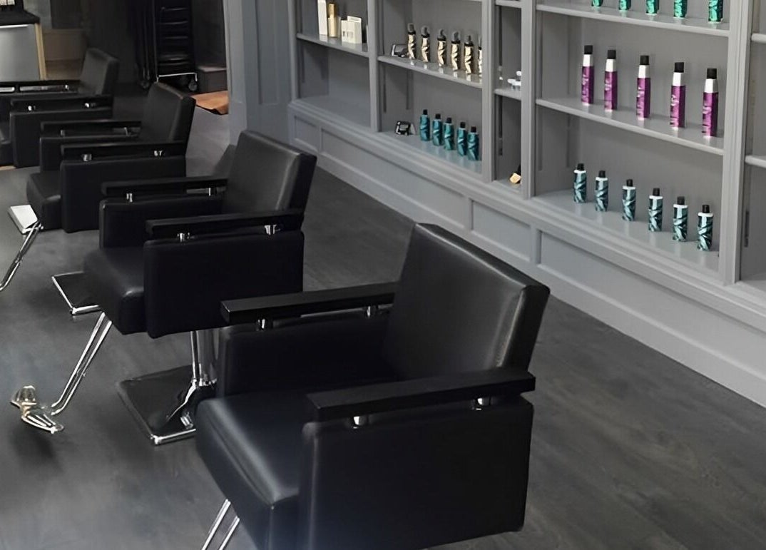 Modern salon interior at Davenports, Carmichael Chatham showcasing sleek chairs and products, Chatham, England, GB.
