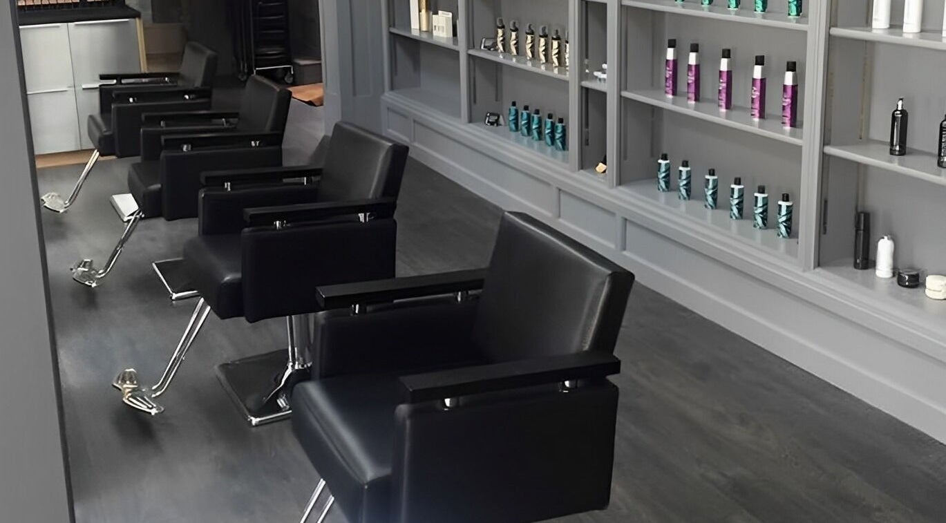 Modern salon interior at Davenports, Carmichael Chatham showcasing sleek chairs and products, Chatham, England, GB.