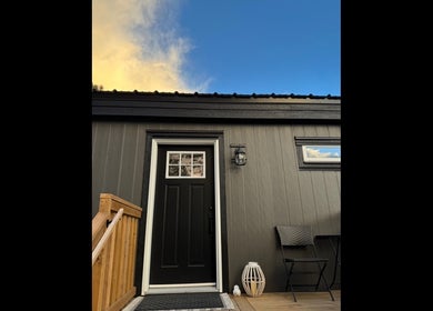 Stylish entrance of Lashes by Alicia, Kamloops, British Columbia, CA with a black door and cozy seating.