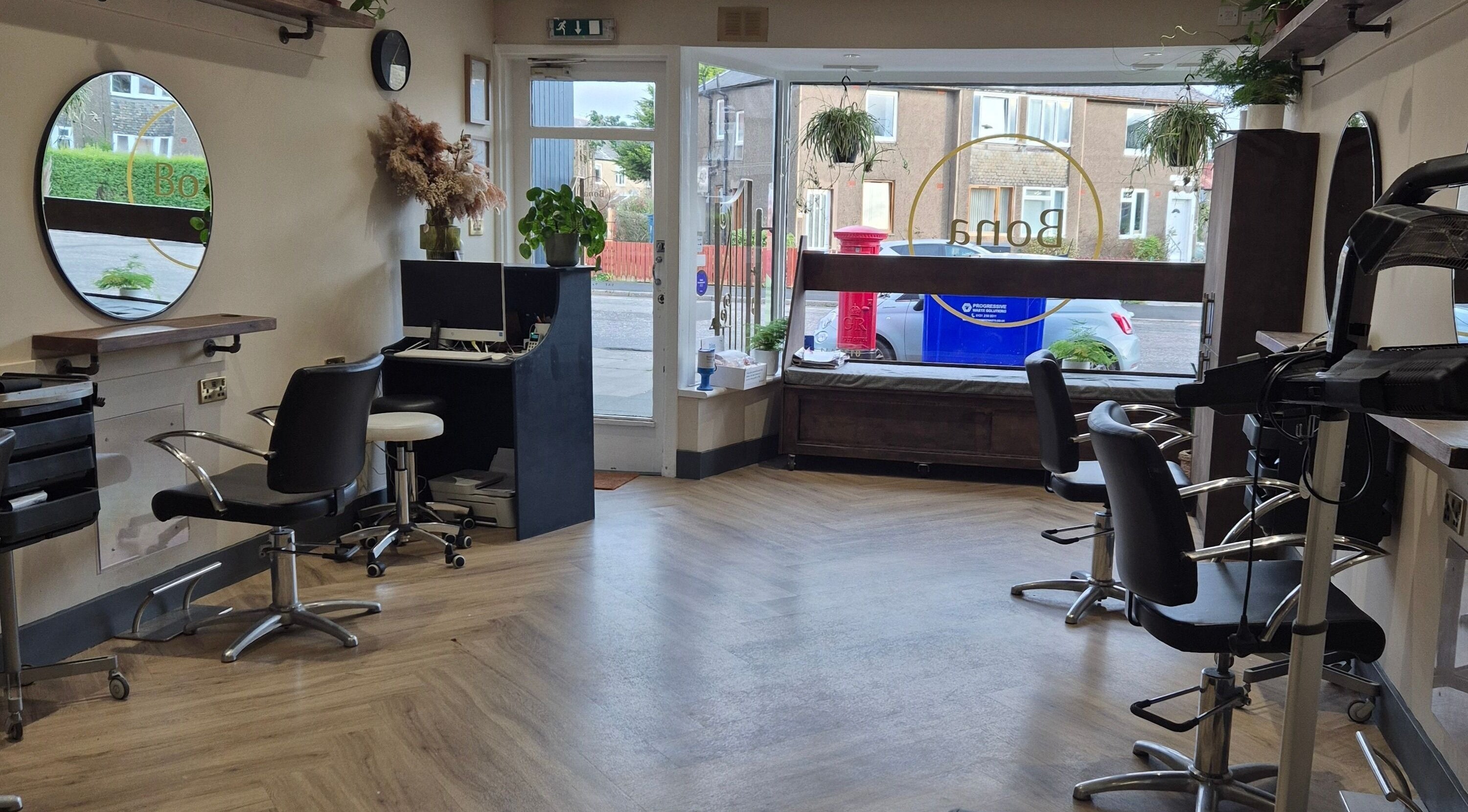 Chic interior of Hair by Brown @ Bona in Edinburgh, Scotland, GB featuring stylish chairs and modern decor.