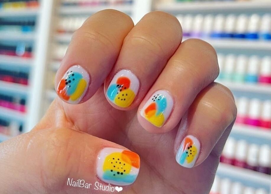 Colorful nail art at NailBar Studio in Naperville, IL, US, showcasing vibrant polishes and intricate designs.