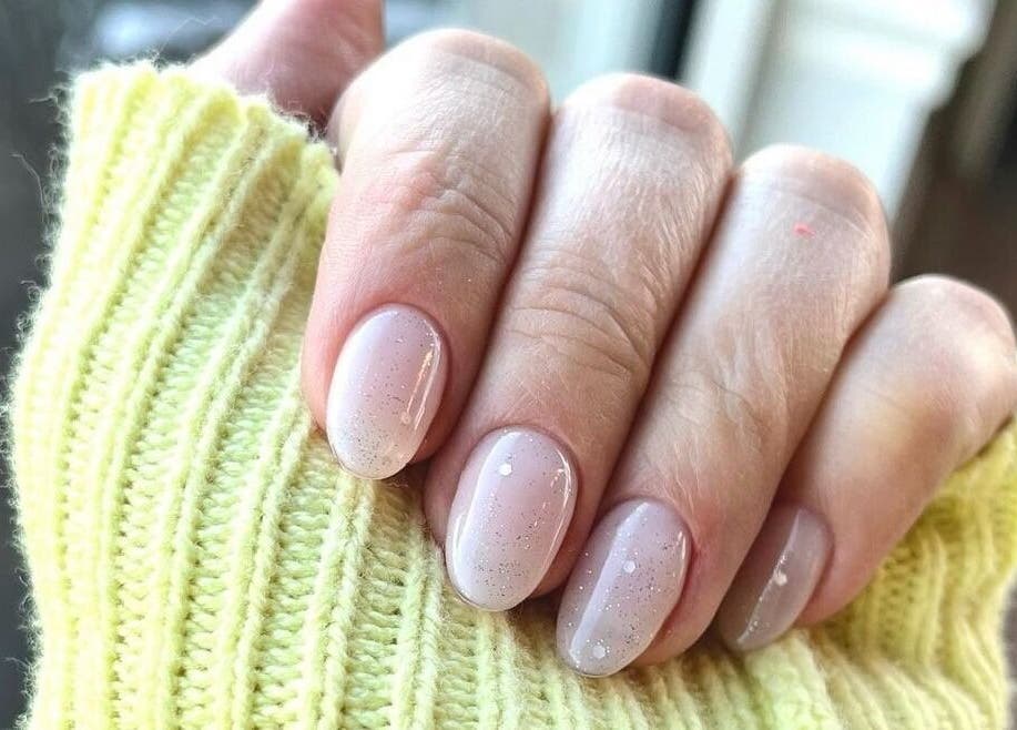 Stylish nude gel nails with sparkles at NailBar Studio, Naperville, IL, US.