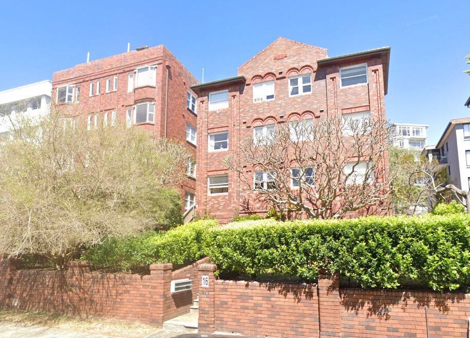 Brick facade of Sheina Mill Studio at Bondi Beach, New South Wales, AU, surrounded by greenery.
