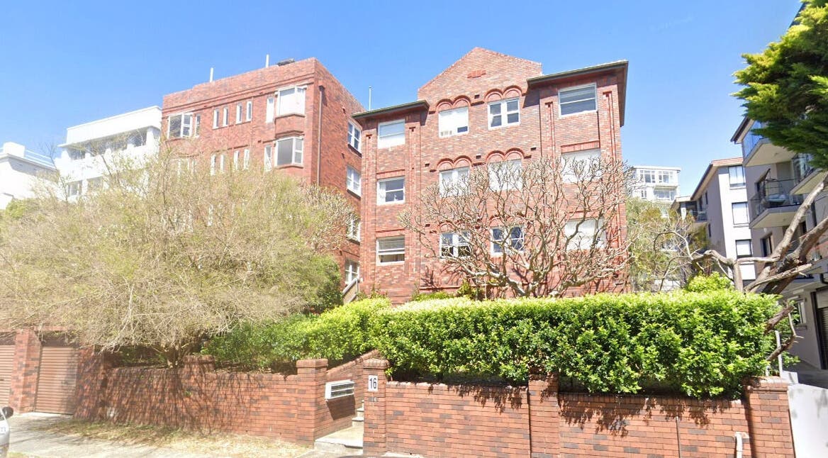 Brick facade of Sheina Mill Studio at Bondi Beach, New South Wales, AU, surrounded by greenery.