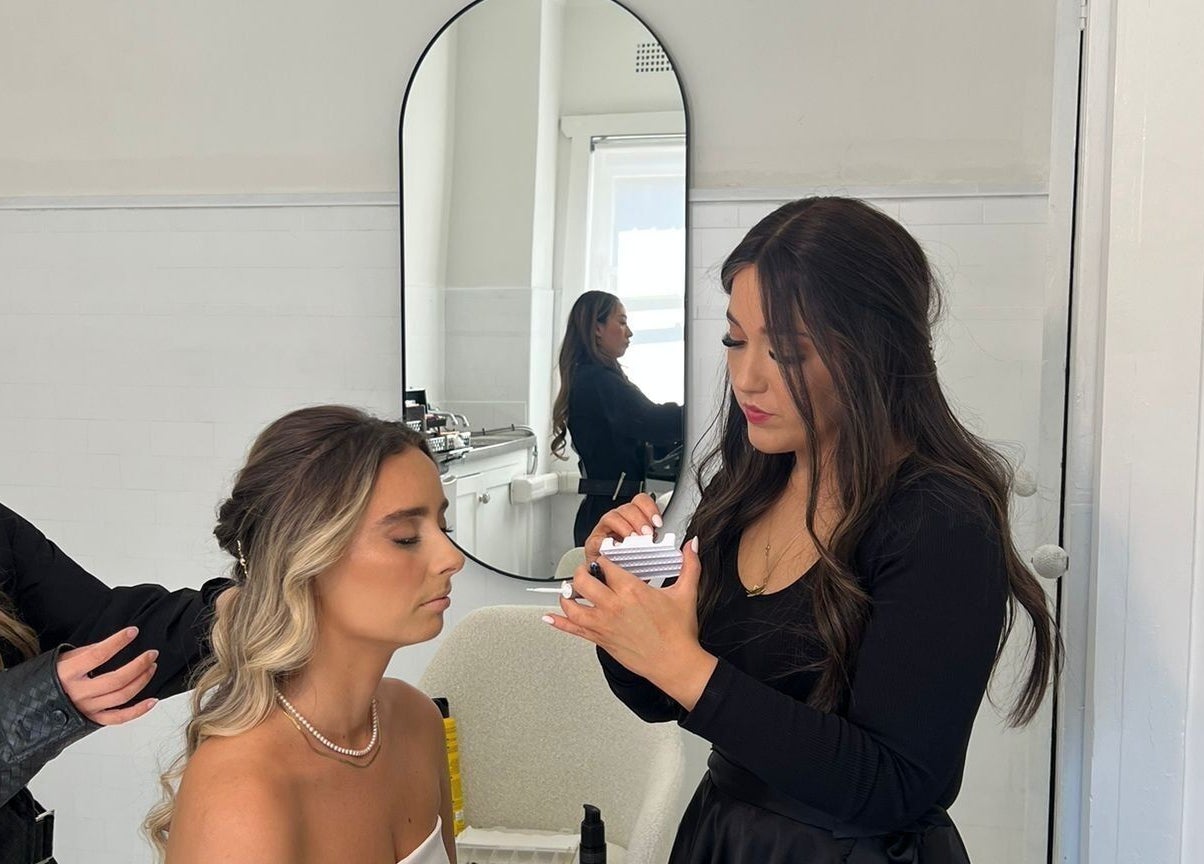 Stylists at Sheina Mill Studio, Bondi Beach, NSW, perfecting a client's look with precision makeup application.